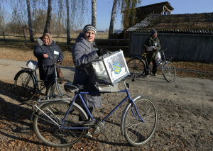 Member of an election commission holds a mobile election box as she visits local residents during a parliamentary election in Horodyshche near Chernihiv